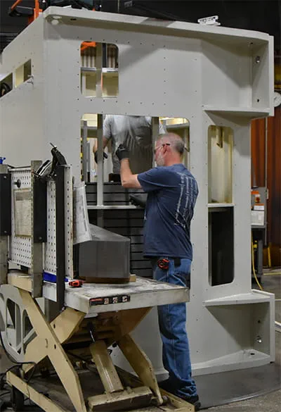 Nidec Power workers stacking laminations